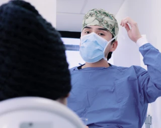 oral surgeon explaining the procedure to his patient