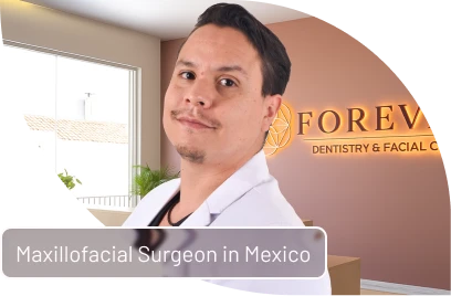 Smiling maxillofacial surgeon portrait with Forever Dentistry clinic branding overlay