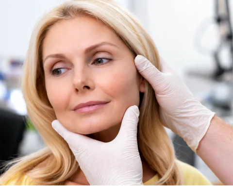 Doctor gently touching patient's nose after healing