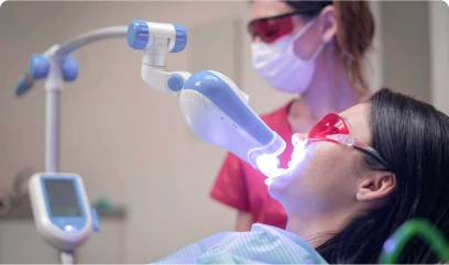 patient under laser whitening teeth treatment