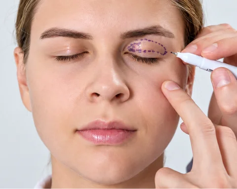 Patient seeing results post-surgery with medical support nearby