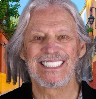 Patient proudly showing their smile after receiving zirconia dental implants