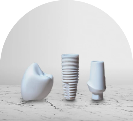 Zirconia crown, implant, and abutment displayed on a marble countertop—highlighting a metal-free, biocompatible dental solution.